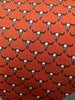 Red necktie with repeating pattern of white bull skulls with black horns