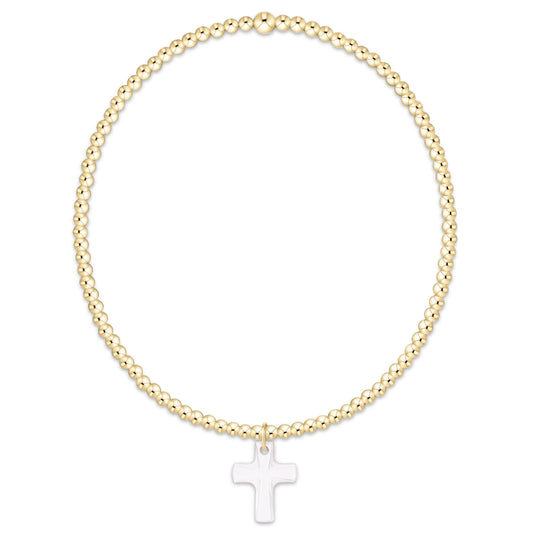 Gold beaded stretch bracelet featuring a white crystal cross charm pendant