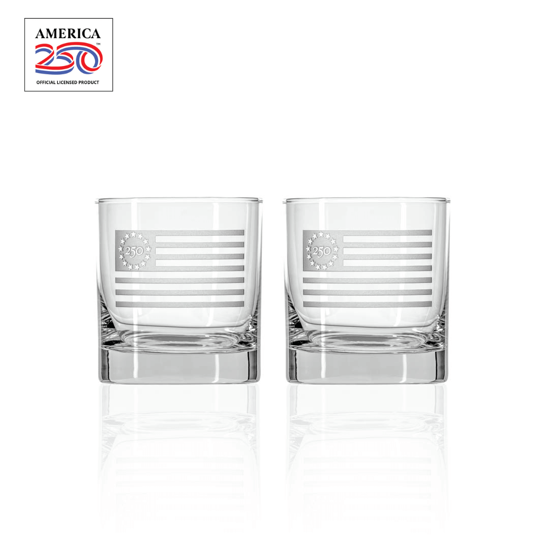Two clear whiskey glasses with etched Betsy Ross flag design featuring 250 anniversary logo