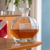 Clear glass whiskey decanter with etched Betsy Ross flag design containing amber whiskey