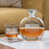 Clear glass whiskey decanter and matching glass with Betsy Ross flag design containing amber whiskey
