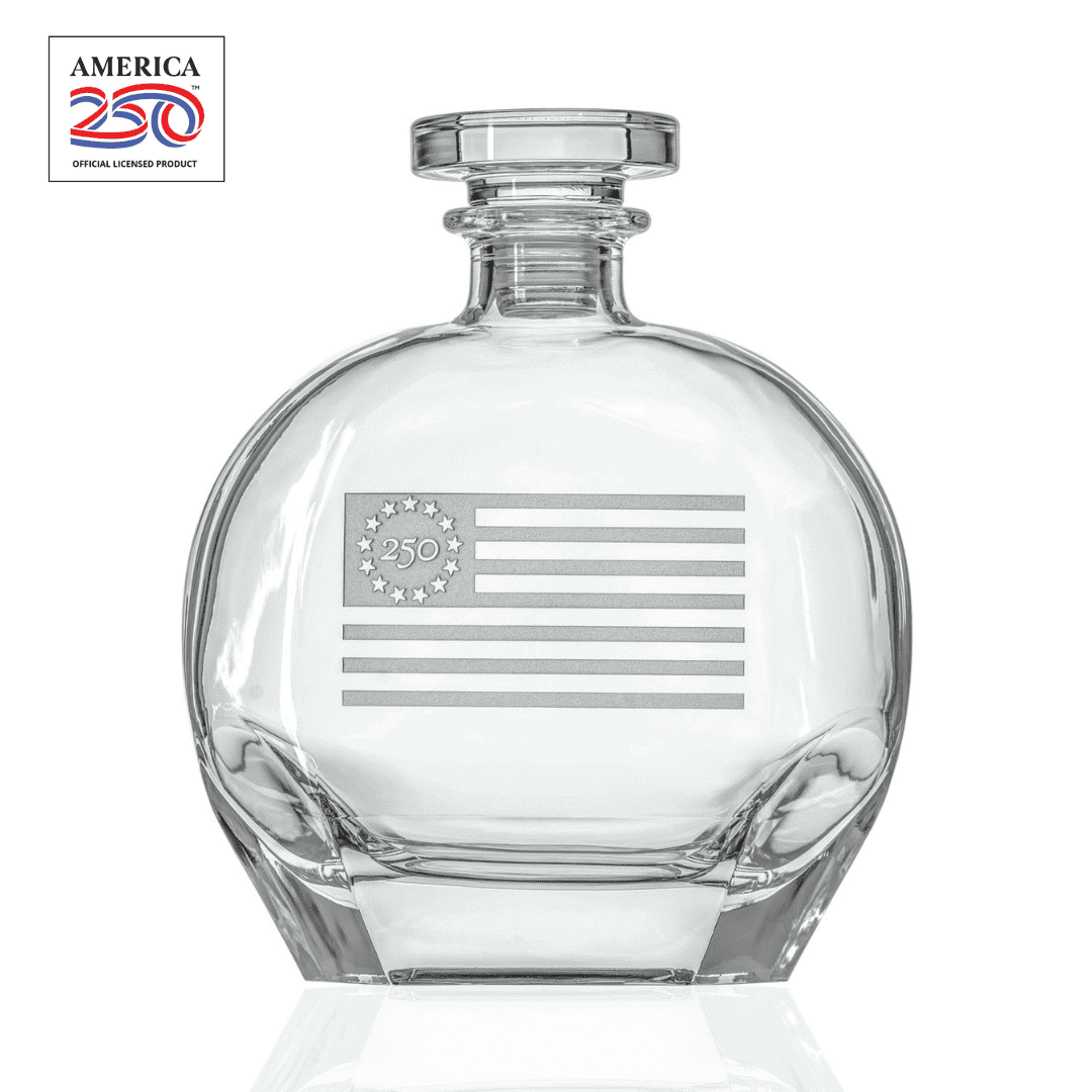 Clear glass whiskey decanter with etched Betsy Ross flag design and America 250 logo