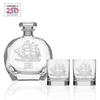 Clear glass whiskey decanter and two rocks glasses with etched tall ship design and America 250 logo