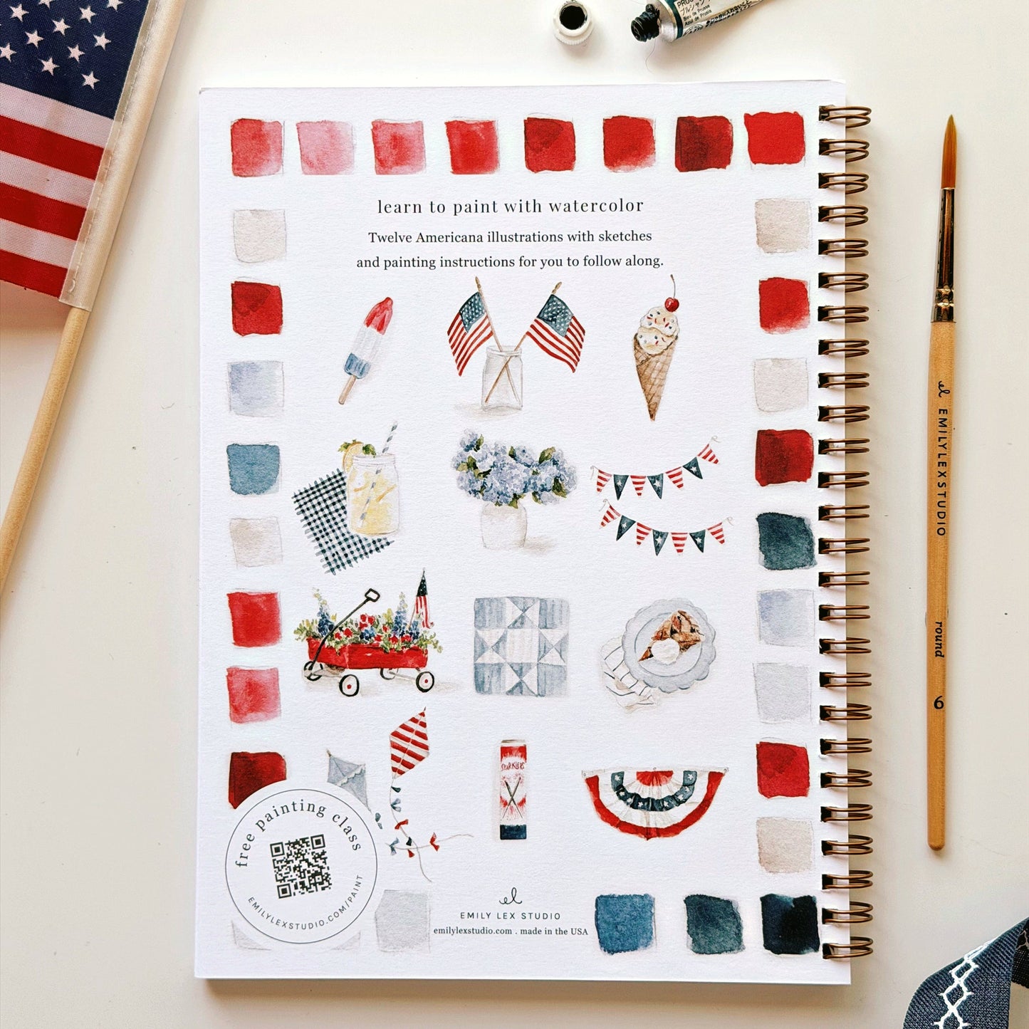 Americana Watercolor Workbook by Emily Lex Studio showing patriotic illustrations with color swatches and paintbrush