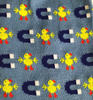 Blue knitted socks with repeating pattern of yellow chicks and dark blue horseshoe magnets on light blue background