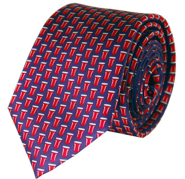 Red and blue patterned necktie rolled up showing geometric design