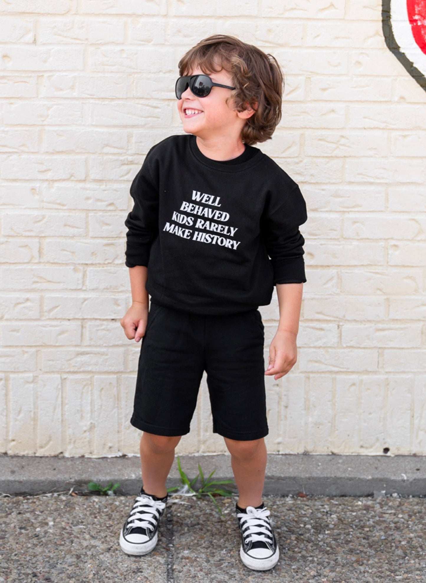 Love Bubby Well Behaved Kids Rarely Make History, Kids Black Sweatshirt available at The Good Life Boutique