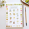 Emily Lex Studio watercolor workbook showing twelve flower tutorials with color swatches and paintbrush