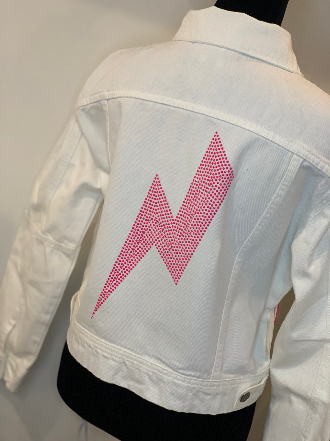 Moving Forward Designs Moving Forward Pink Bolt and Stud White Denim Jacket available at The Good Life Boutique