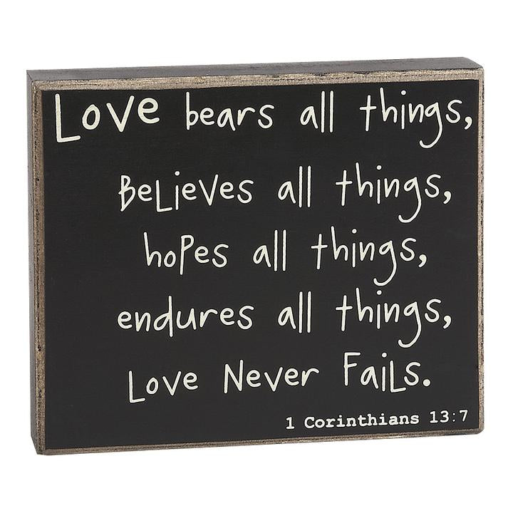 Collins Painting & Design, LLC Love Never Fails Wood Sign available at The Good Life Boutique